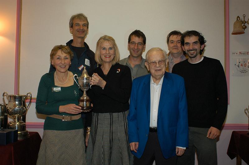 image007.jpg - Loulou Van Guens and Kate Manners collect their trophies with their team-mates, the winning team of Robson, Allfrey, Forrester and Robson with Bernard Teltscher, LMBA President in the foreground.